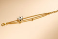 Chic Triple Strand Gold Chain Bracelet with Enamel Panda & Gold Bead Accents