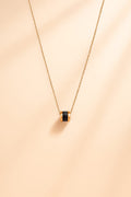 Elegant Gold-Tone Chain Necklace with Black Ribbed Barrel Pendant